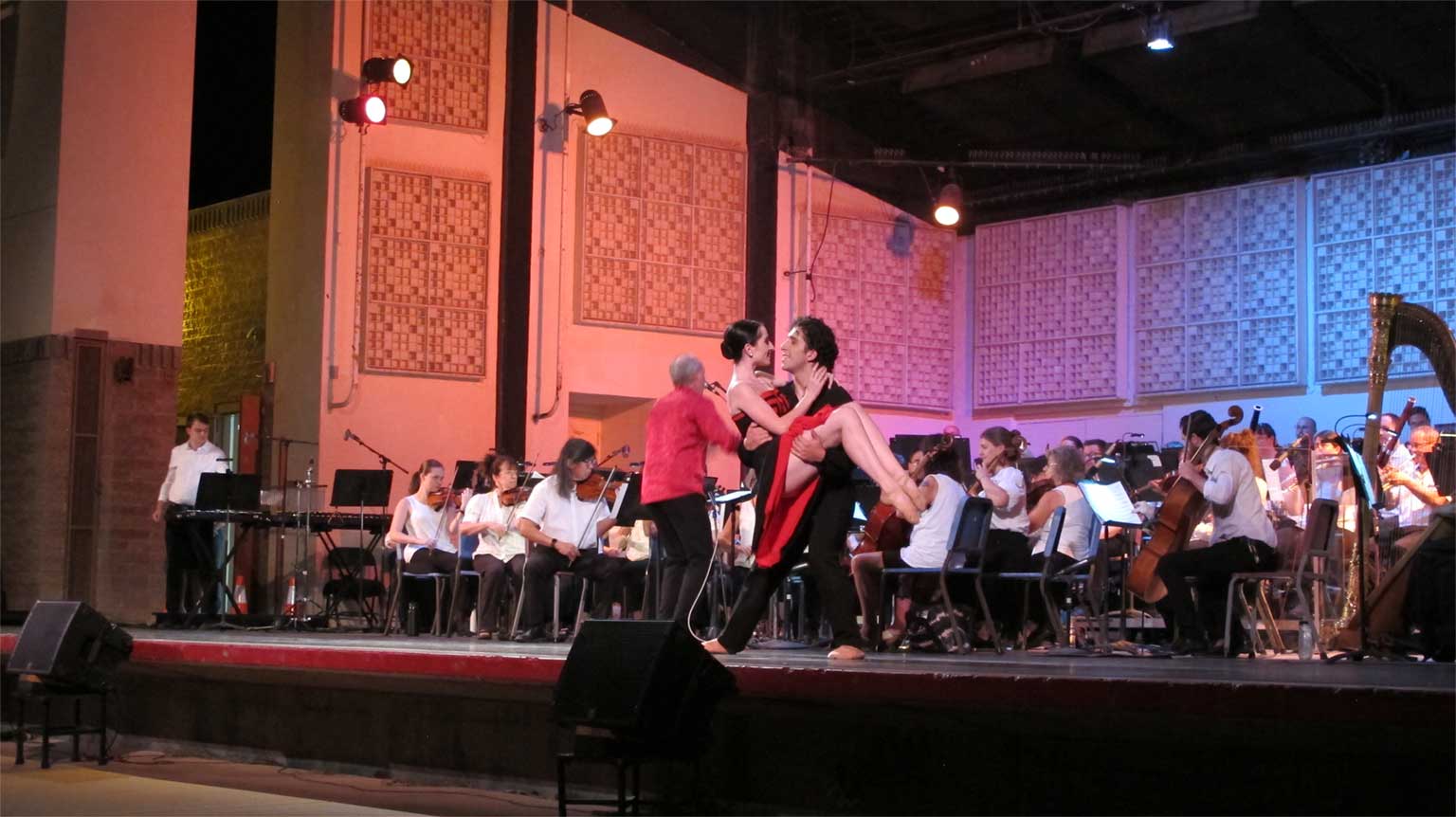 Two dancers on stage with the Tucson Pops Orchestra